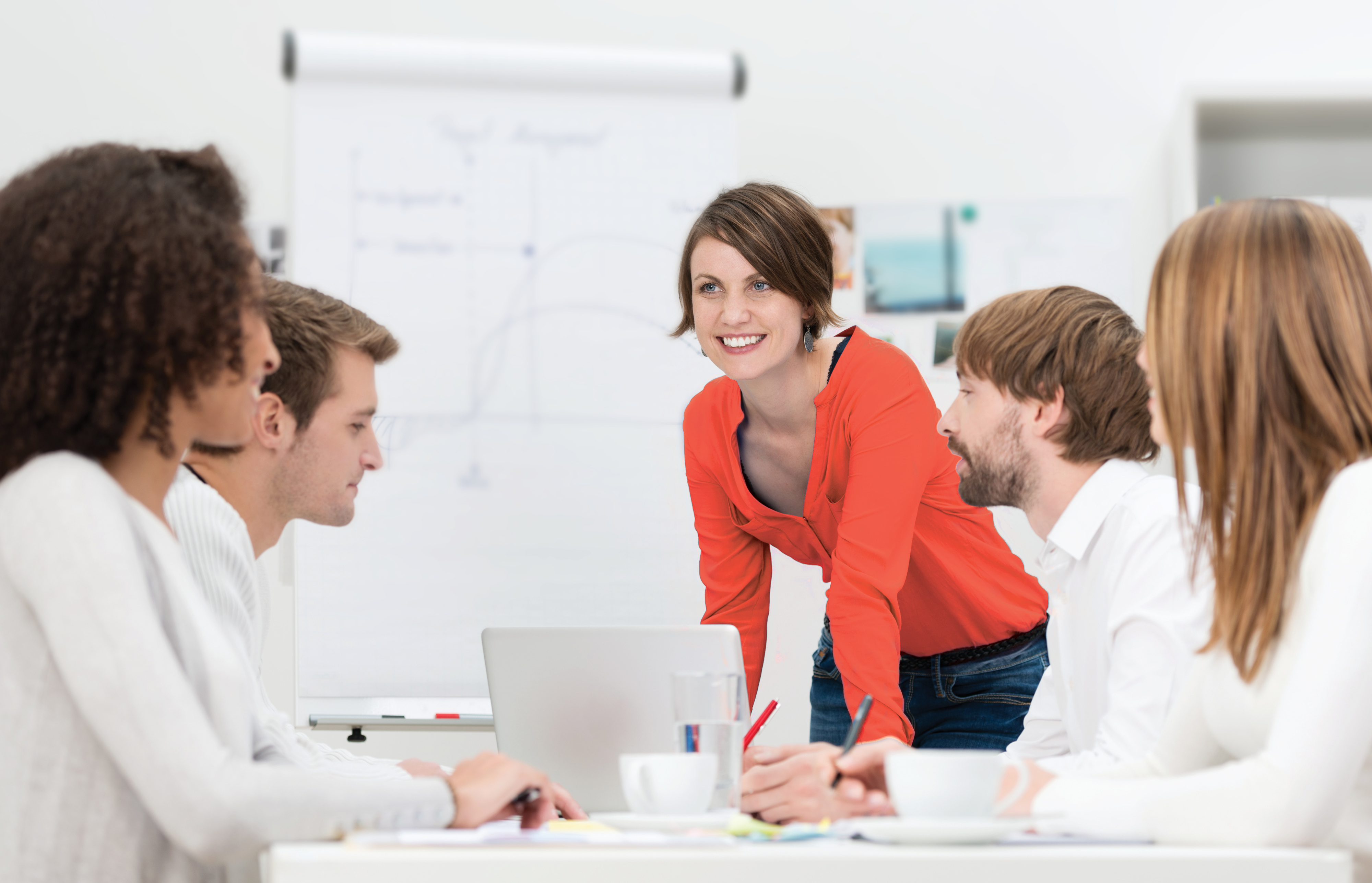 With "IT-Security as a Service" you rent your hardware and software Woman with red top in a meeting with people dressed in white